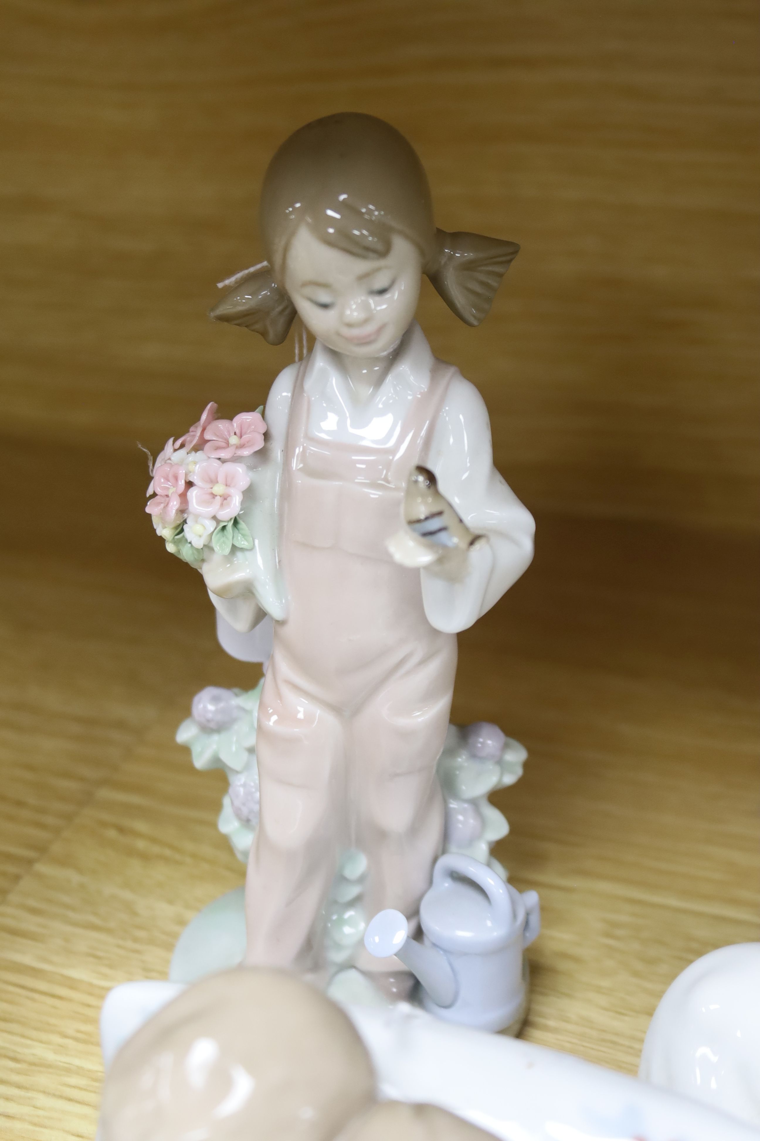 Five Lladro figures, comprising 'An Elegant Touch', 'Spring', 'Little Dreamers', 'Bearly Love' and a goose